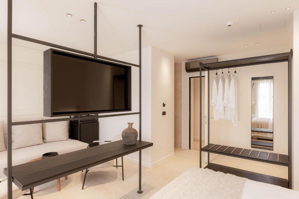 a living room with a large flat screen tv at Doryssa Theorem Hotel in Pythagoreio