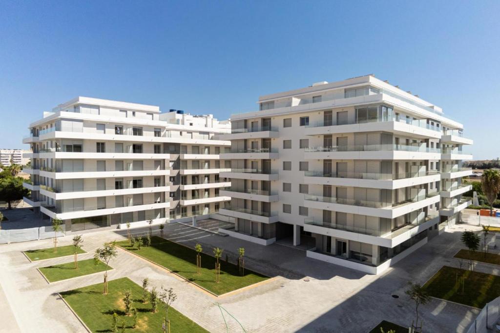 een appartementencomplex met twee hoge witte gebouwen bij Nueva andalucia, apartment for rent in Marbella