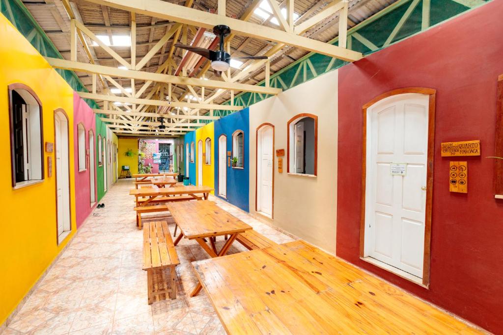 a row of benches in a room with colorful walls at Hostel da Milla in Presidente Figueiredo