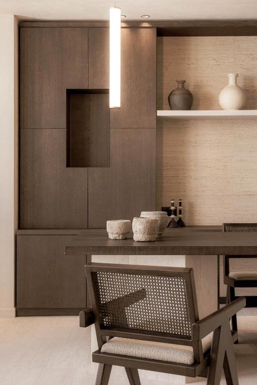 a dining room with a table and a chair at Doryssa Theorem Hotel in Pythagoreio