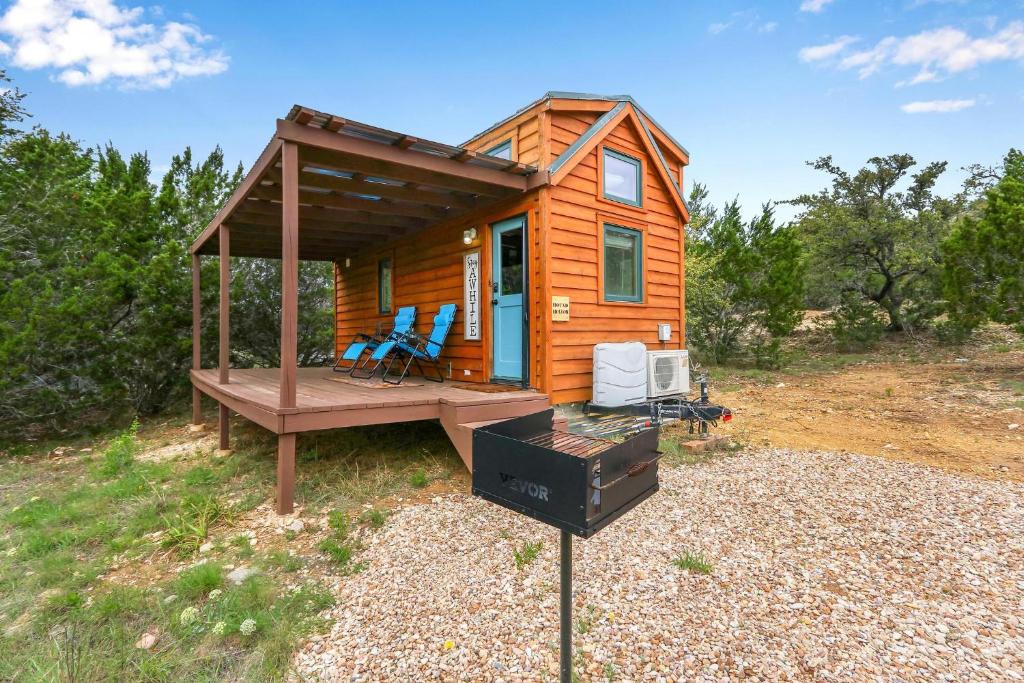a tiny house with a porch and a grill at Arbor House of Dripping Springs - Hound Hollow in Dripping Springs