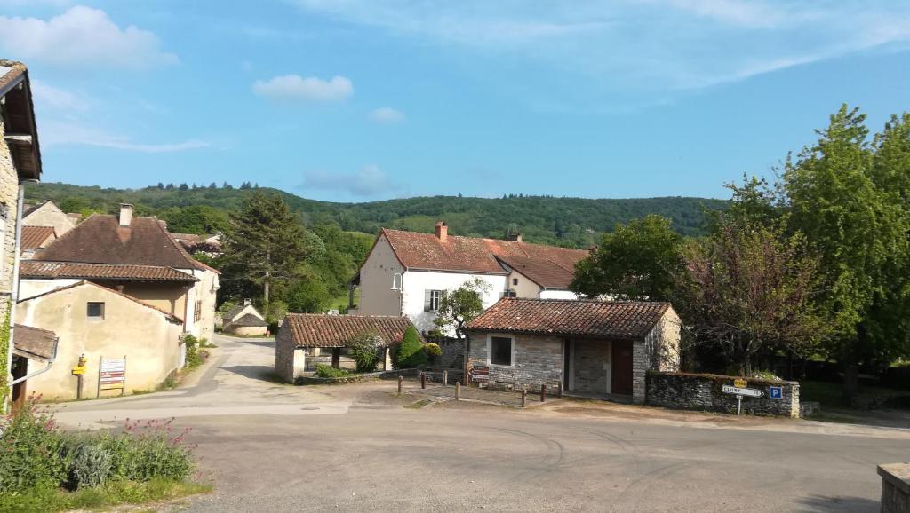 a small village with houses and a road at Les chambres de Blanot in Blanot