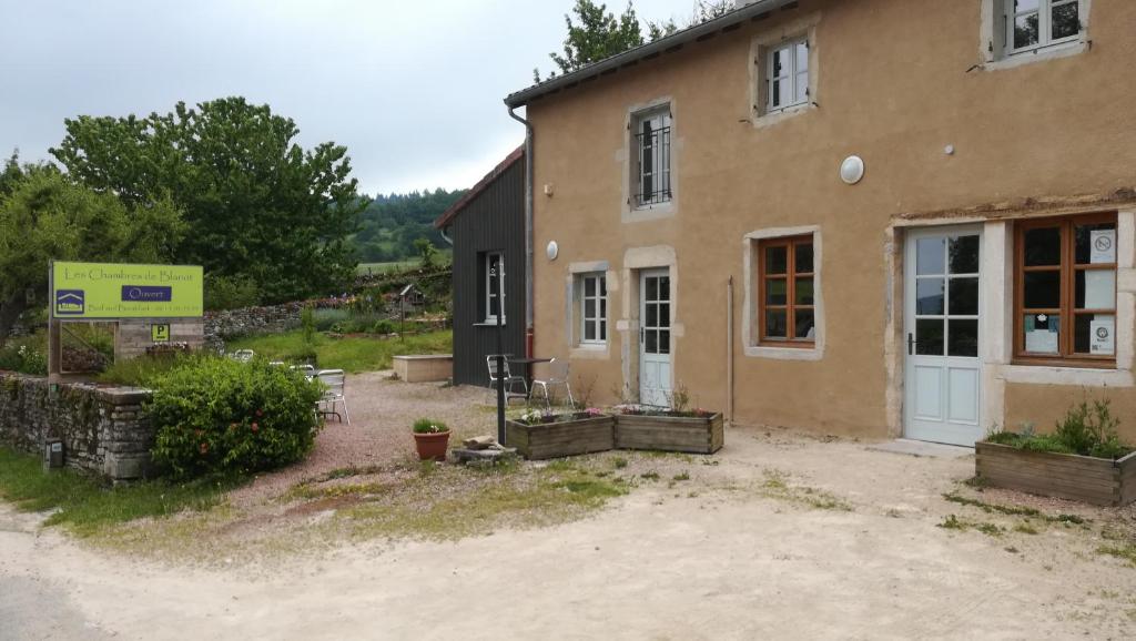 a building with a sign in front of it at Les chambres de Blanot in Blanot