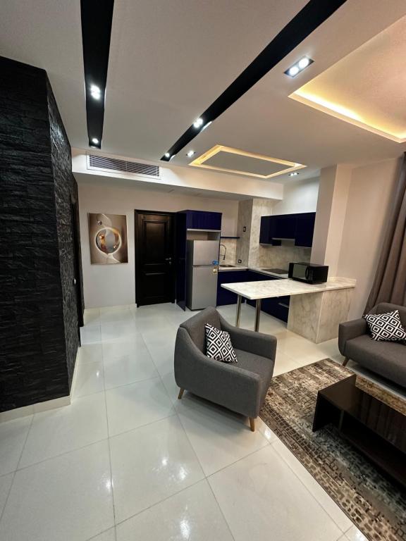 a living room with a couch and a table at Cozy Elite One Bedroom Apartment in Sheikh Zayed