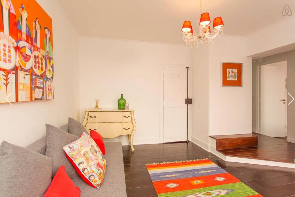 a living room with a couch and a table at Shabby Chic Bairro Alto in Lisbon