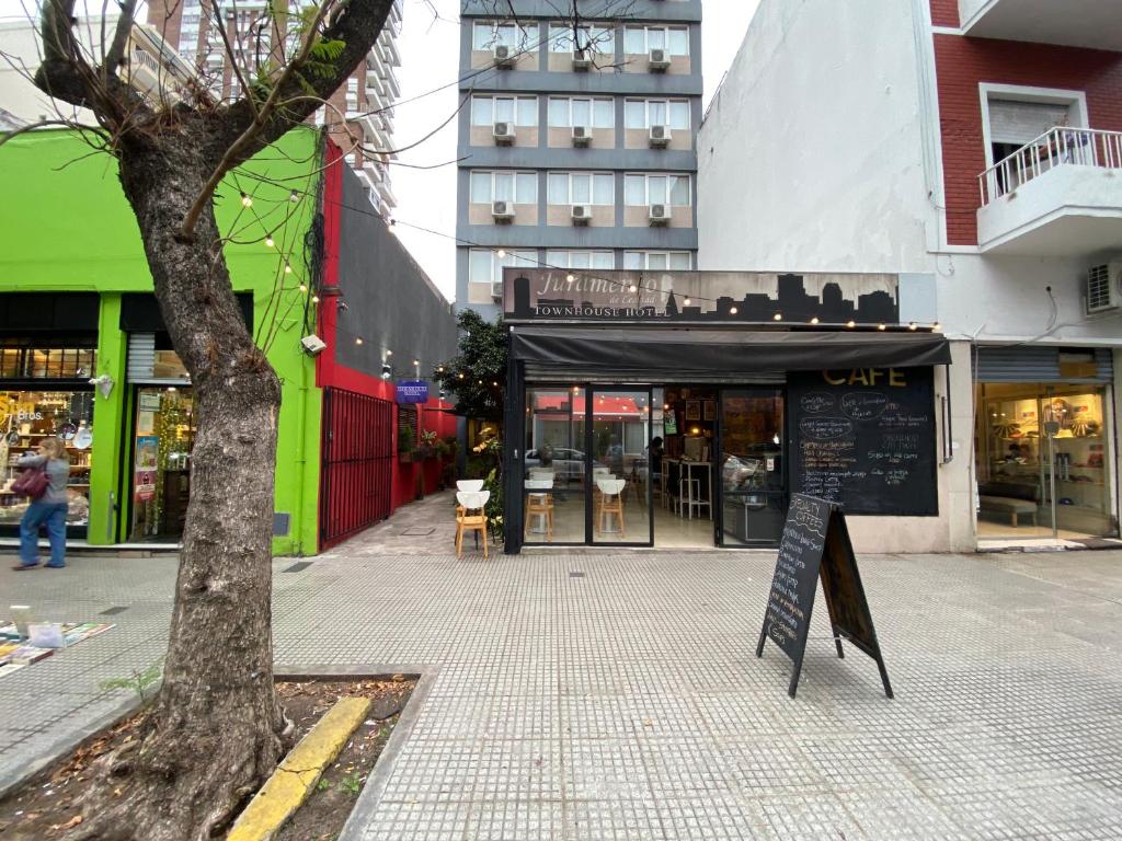 a street with a sign in front of a building at Juramento de Lealtad Townhouse Hotel in Buenos Aires