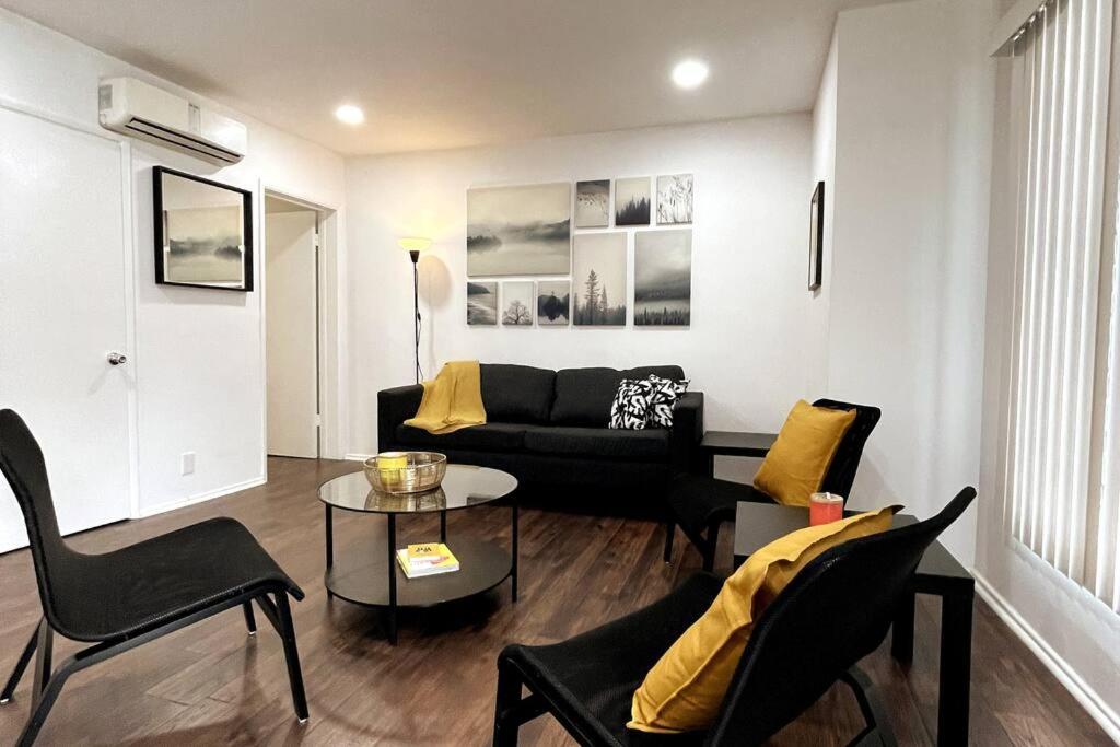 a living room with a couch and a table at Hollywood Business Apartments in Los Angeles