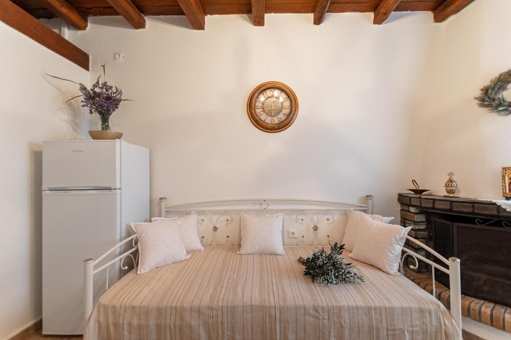 a bedroom with a bed with a white refrigerator at Ktima Dimitrios in Naxos Chora