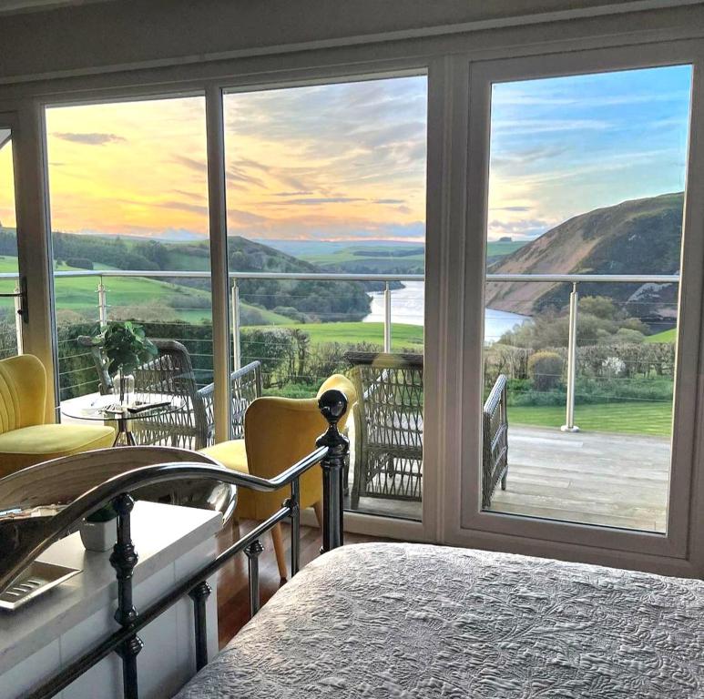 a bedroom with a large window with a view at Ty Capel in Llanidloes