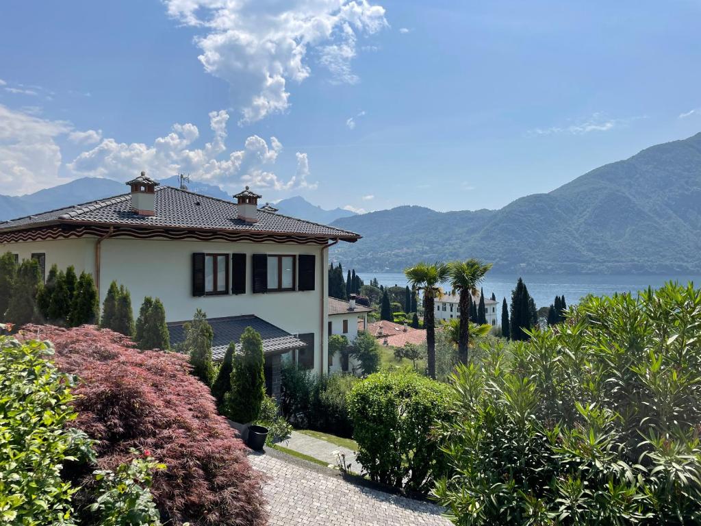 a house with a view of the water and mountains at Residenza Margherita in Tremezzo