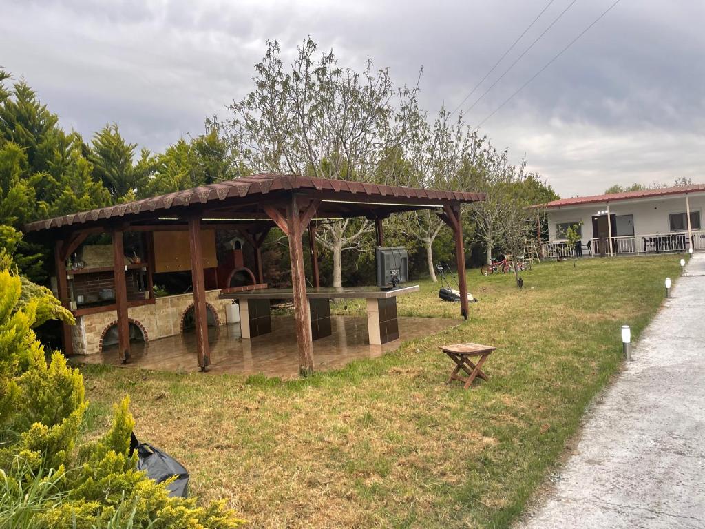 a gazebo in the yard of a house at LION VILLAGE in Skala Fourkas