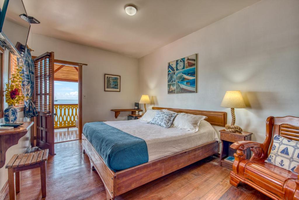 a bedroom with a bed and a balcony at Hotel Bocas del Toro in Bocas del Toro
