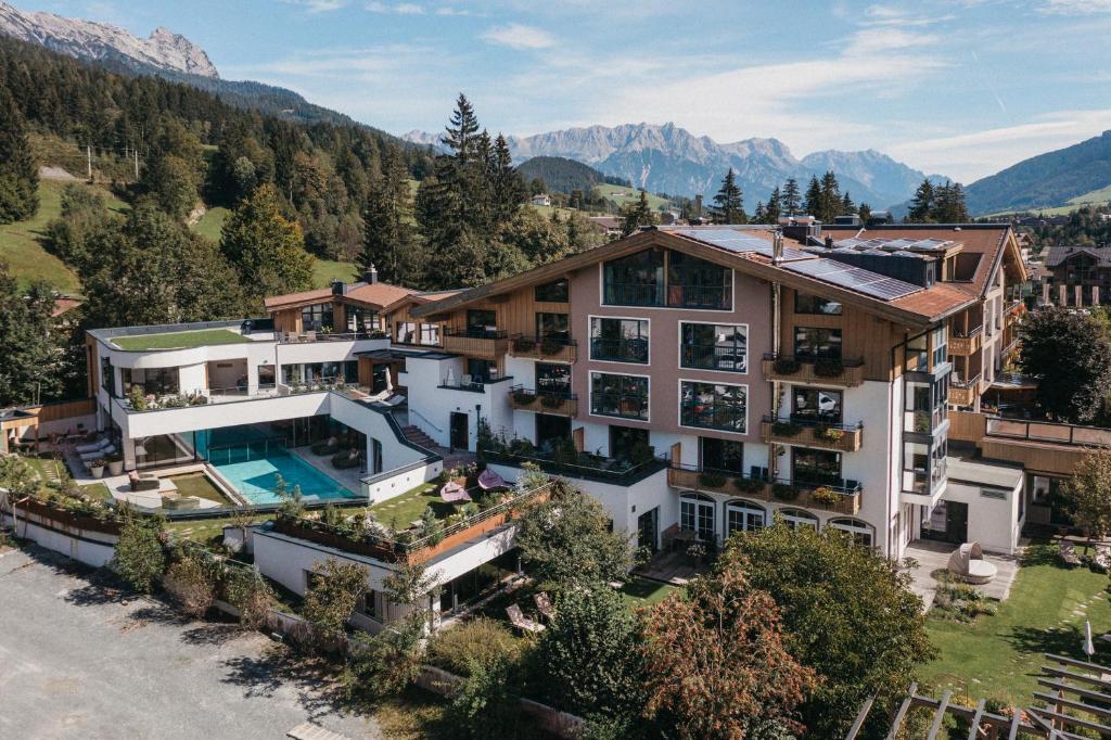 an aerial view of a house in the mountains at Biohotel Rupertus in Leogang