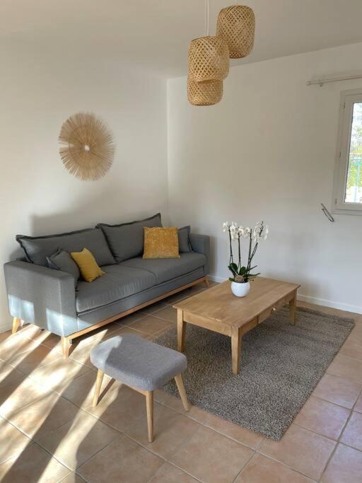 a living room with a couch and a coffee table at Le calme de la campagne proche de tout..... in Les Arcs sur Argens