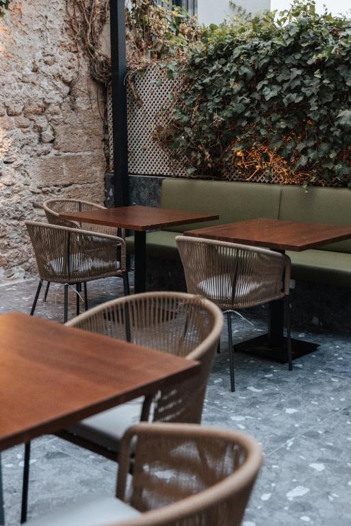 a group of tables and chairs in a restaurant at Boutique Hotel OLOM - Only Adults recommended in Cádiz