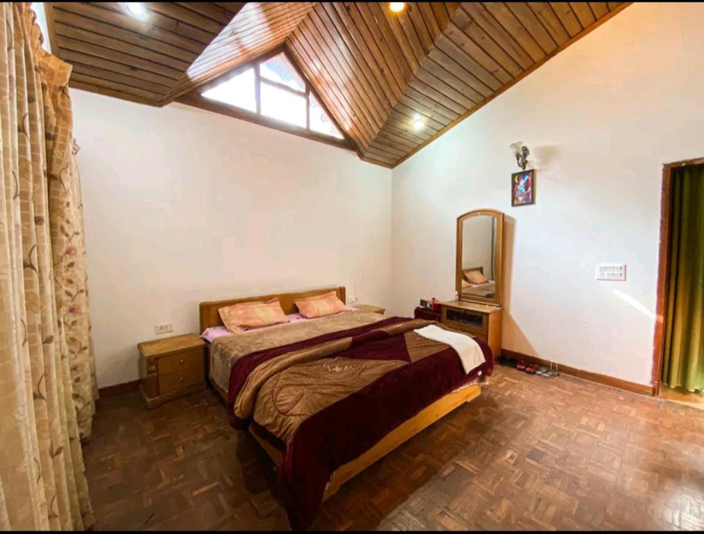 a bedroom with a bed and a large window at Woods Luxury Homestay in Nainital