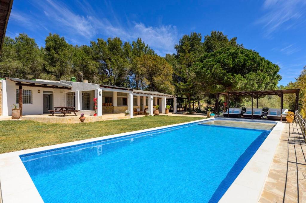 an image of a swimming pool in front of a house at Villa Jazmin in Sant Llorenç de Balafia