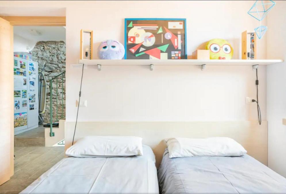 Postel nebo postele na pokoji v ubytování Foresteria B&B Vecchiascuola Pianazzola