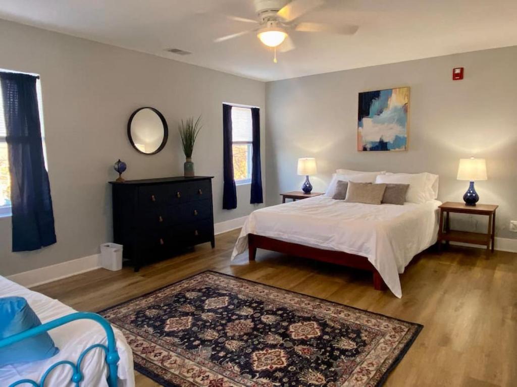 a bedroom with a bed and a dresser and a mirror at SJ Suburban HiDeAwAy 