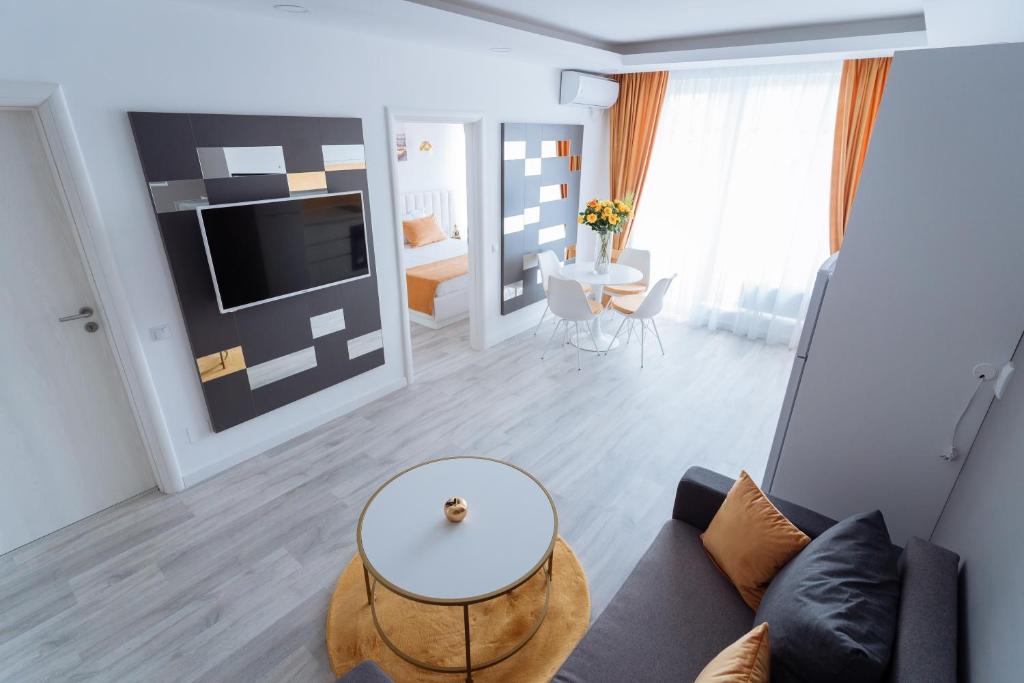 a living room with a couch and a table at GoldenLux Apartments in Oradea