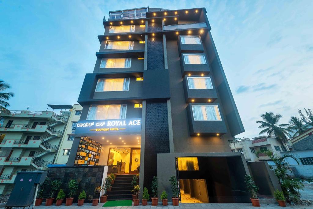 a tall building with lights on top of it at Royal Ace Boutique Hotel - Manyata Techpark in Bengaluru