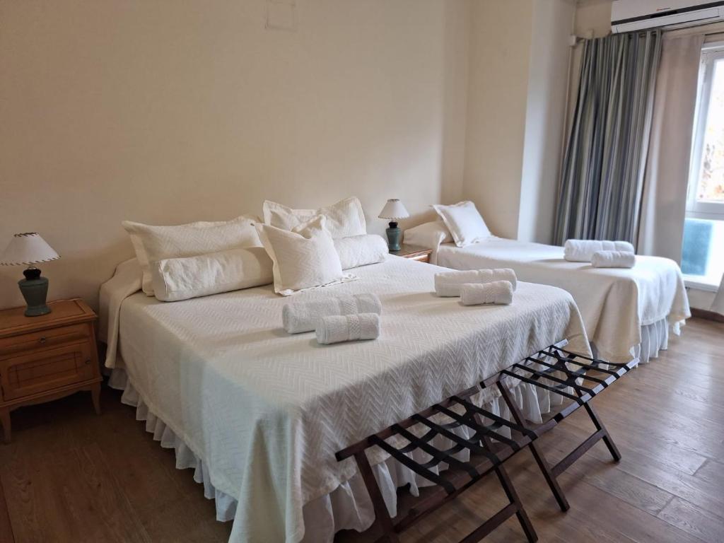 1 dormitorio con 2 camas con sábanas blancas en Hotel Turingia en Miramar
