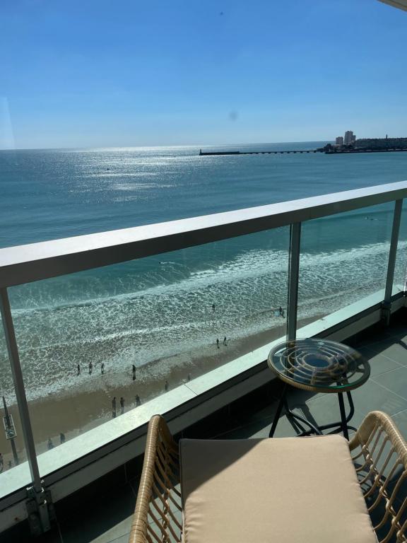 a balcony with a view of the beach and the ocean at Face Mer vue d'exception Studio rénové au 9ème étage in Les Sables-dʼOlonne