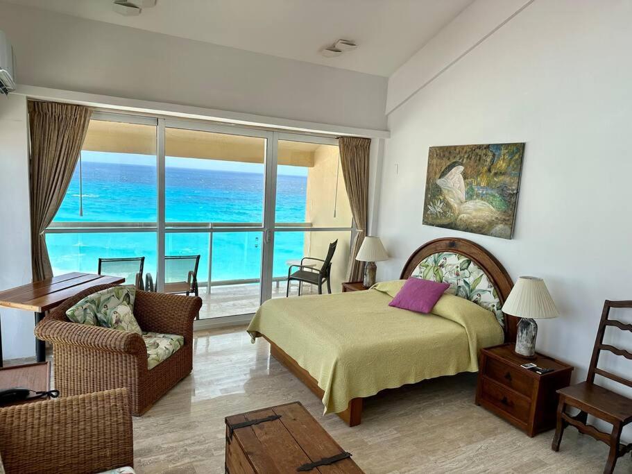 a bedroom with a bed and a view of the ocean at Penthouse 1AB on the beach with sea views in Cancún