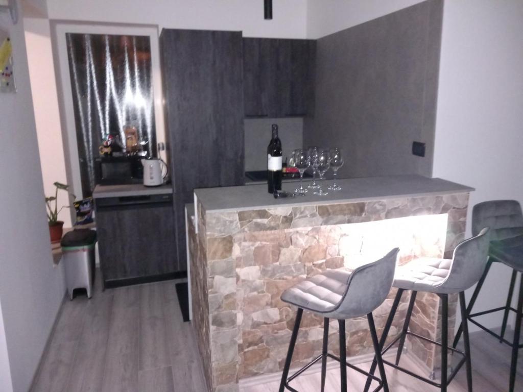 una cucina con bar e camino in pietra di Apartman ANI a Fiume (Rijeka)