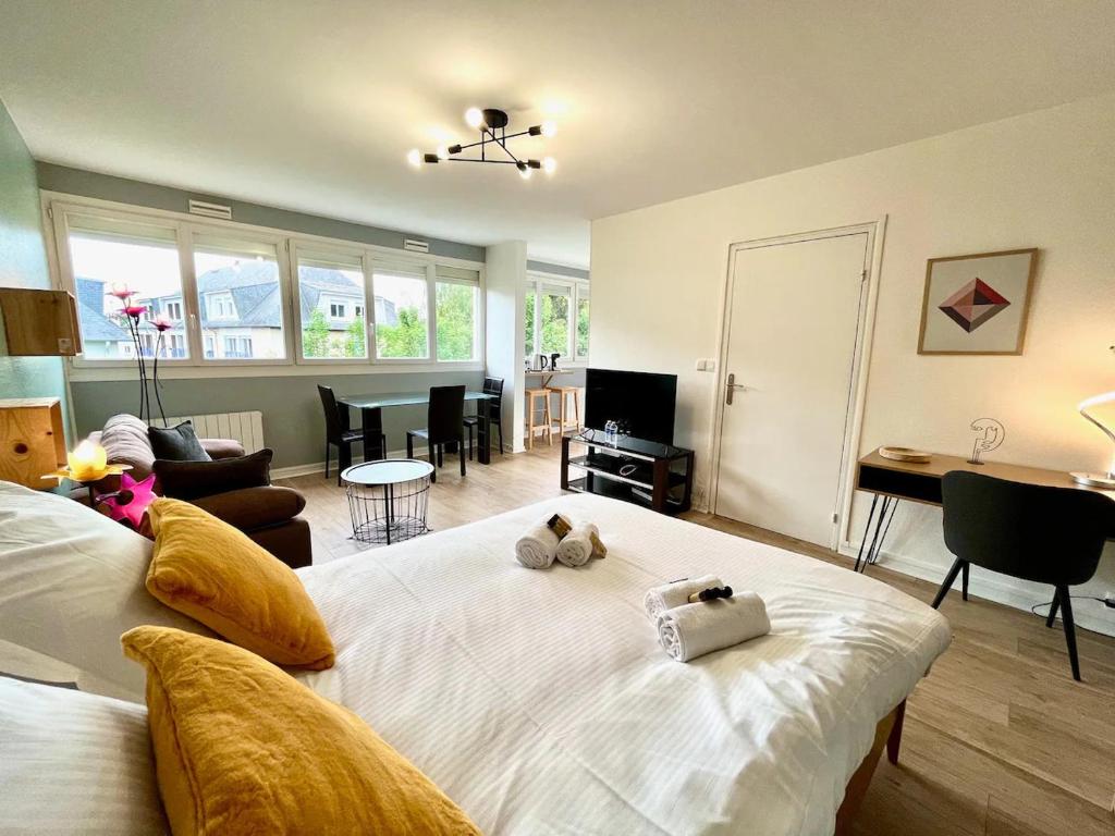 a bedroom with a large bed with two stuffed animals on it at Khara - SILS in Caen