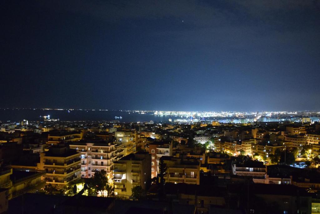 a view of a city at night at Toumba apartments in Thessaloniki