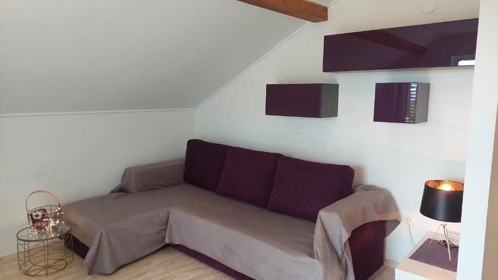 a living room with a couch in a room at Apartments Nikola Caska in Novalja