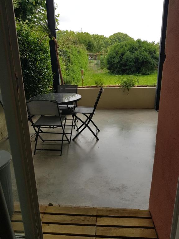 a view of a patio with a table and chairs at Maison Mïa&Leandro in Mauguio