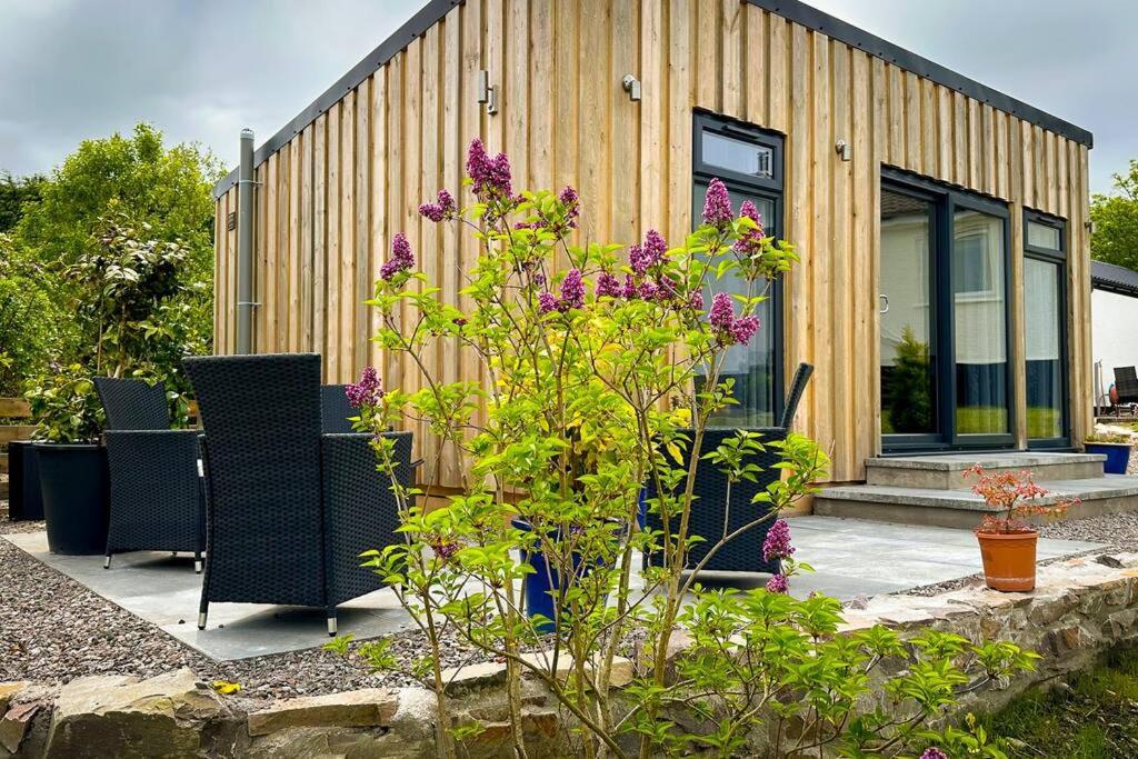 a house with purple flowers in front of it at Ardvreck Chalet self-catering in Kyleakin