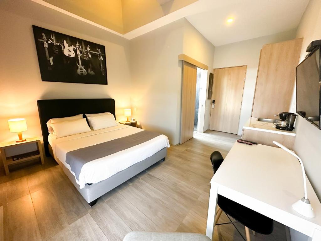 Postel nebo postele na pokoji v ubytování Hotel Arena Suites Movistar Arena