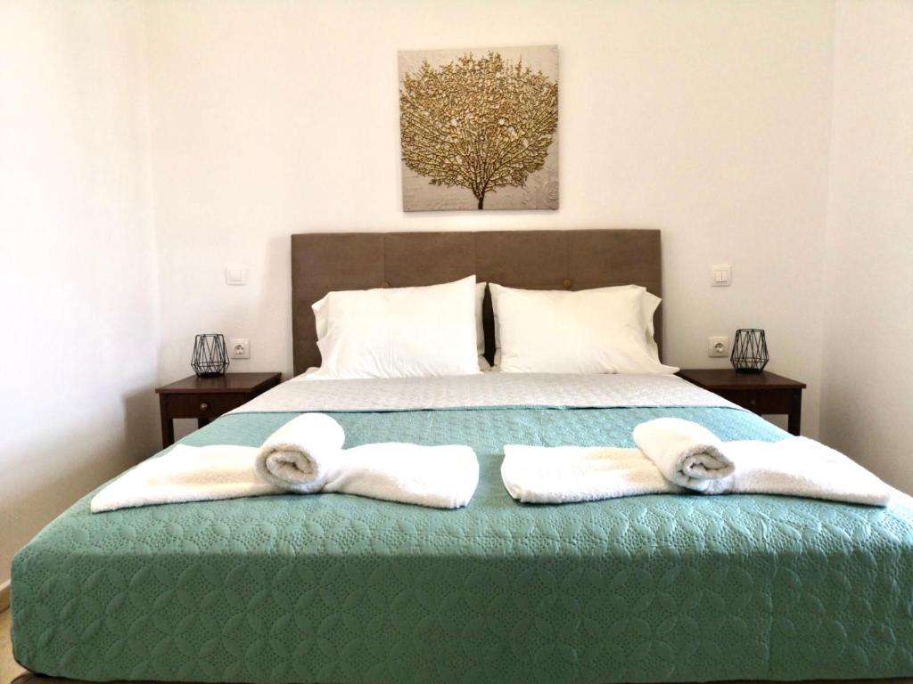 a bedroom with a bed with towels on it at Yanna's Apartments in Sidari