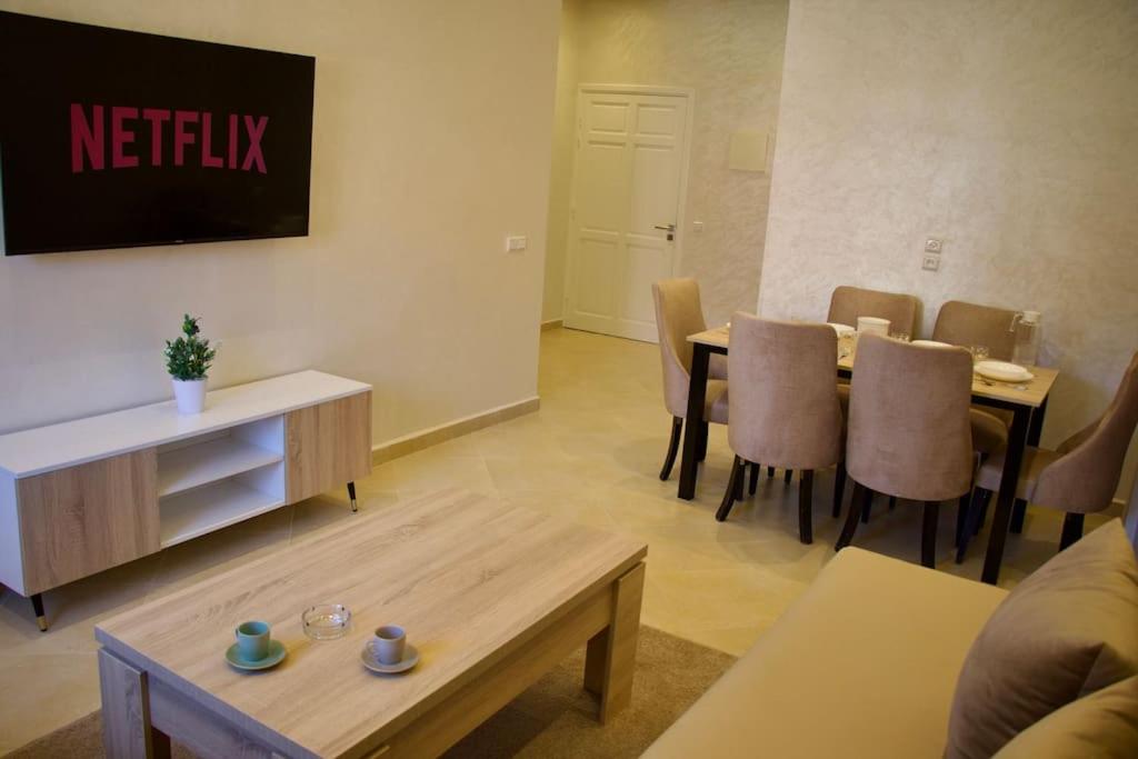 salon ze stołem i krzesłami w obiekcie Magnifique appartement Marrakech w Marakeszu