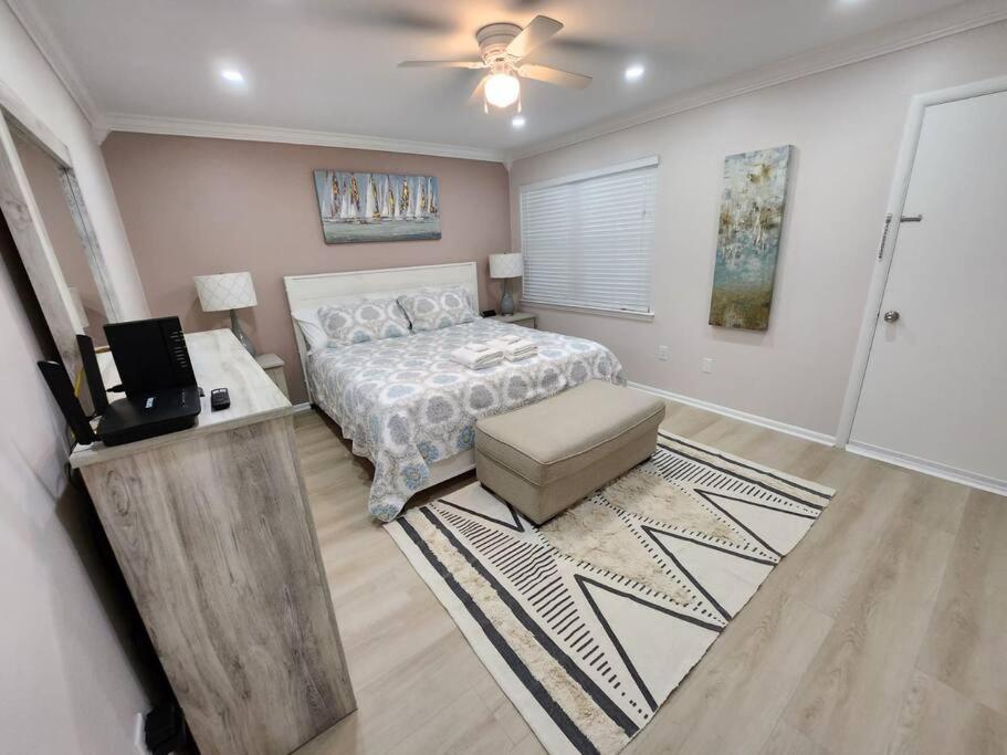 a bedroom with a bed and a table and a television at Serenity in Paradise in Hilton Head Island