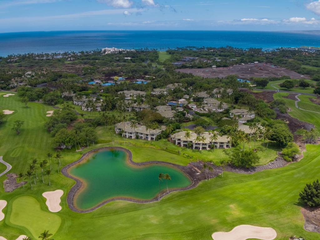 an aerial view of the golf course at the oceanfront resort at The Islands at Mauna Lani Point - CoralTree Residence Collection in Waikoloa