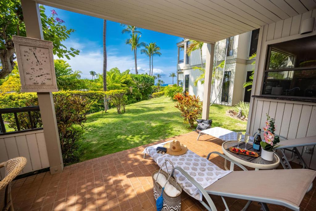 a patio with a table and chairs on a porch at Ekolu 1403 in Wailea