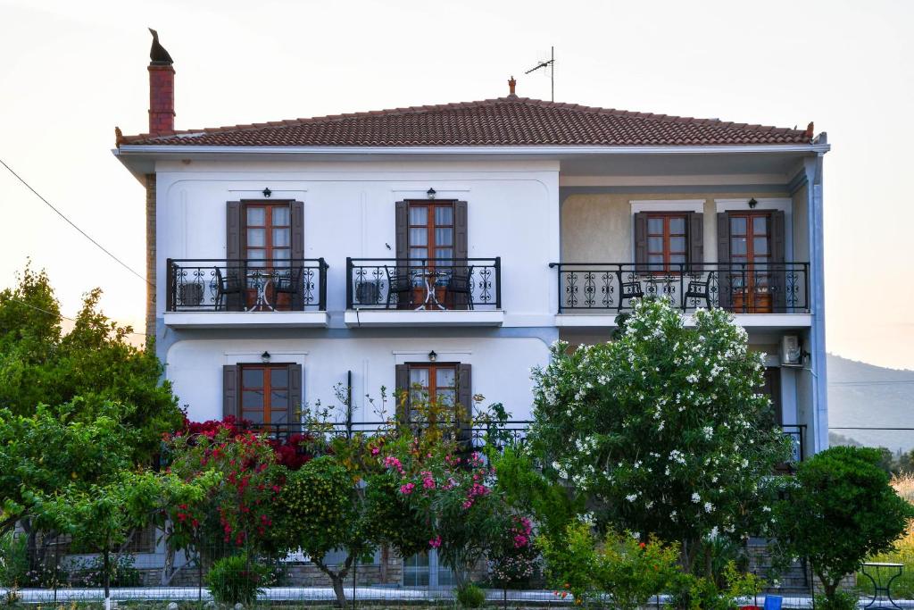 um edifício branco com janelas e varandas em Chrys Marie Studios em Iraion