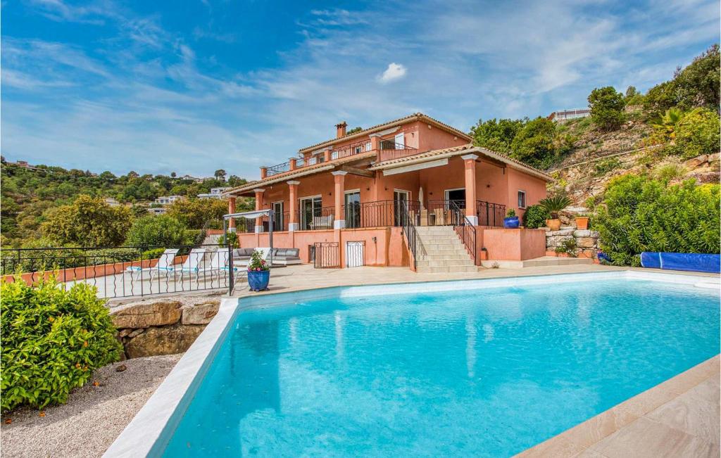 a house with a swimming pool in front of a house at Stunning Home In Les Adrets-De-L'estére in Les Adrets de l'Esterel