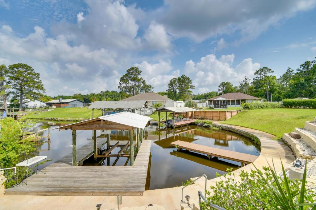 a house with a dock and a waterway at East Palatka Vacation Rental, Anglers Paradise in East Palatka