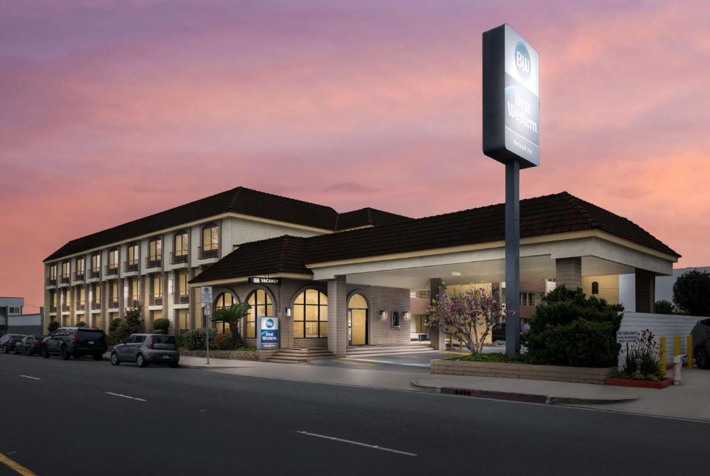 a rendering of a building with a gas station at Best Western Norwalk Inn in Norwalk