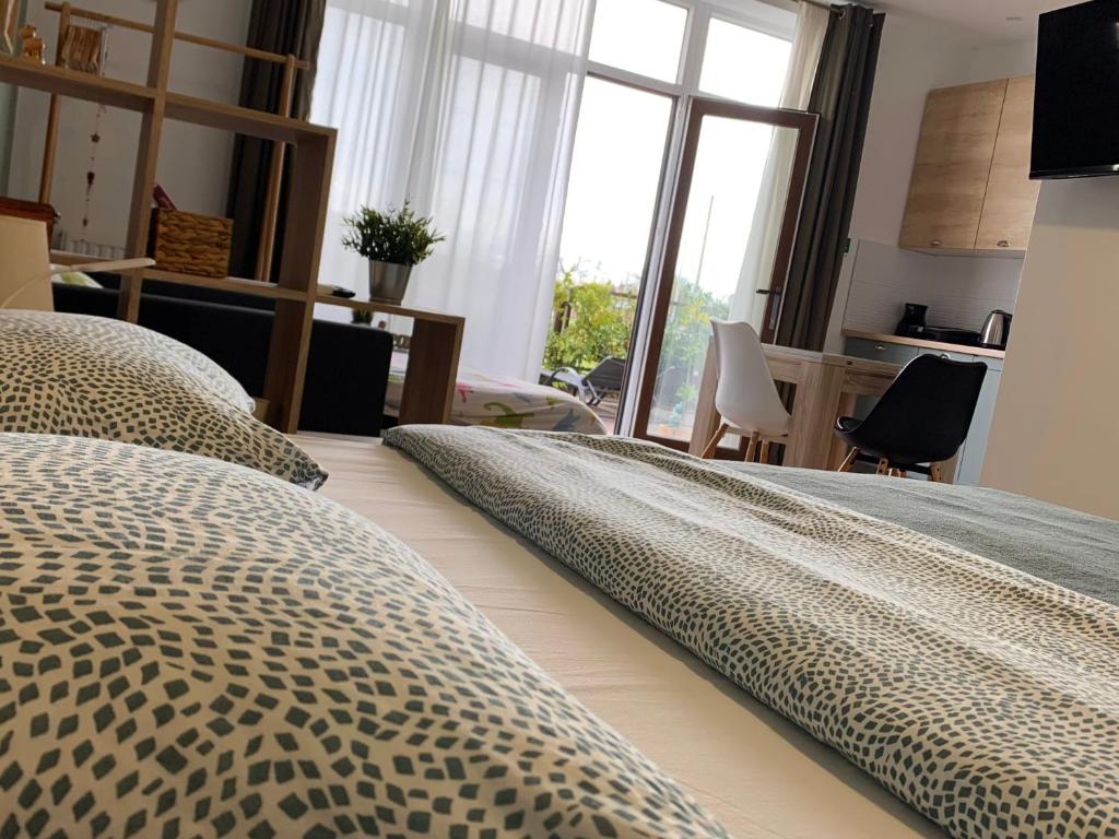 a bedroom with a bed with a leopard print blanket at NOAR Apartment, NEW STUDIO in Orešje