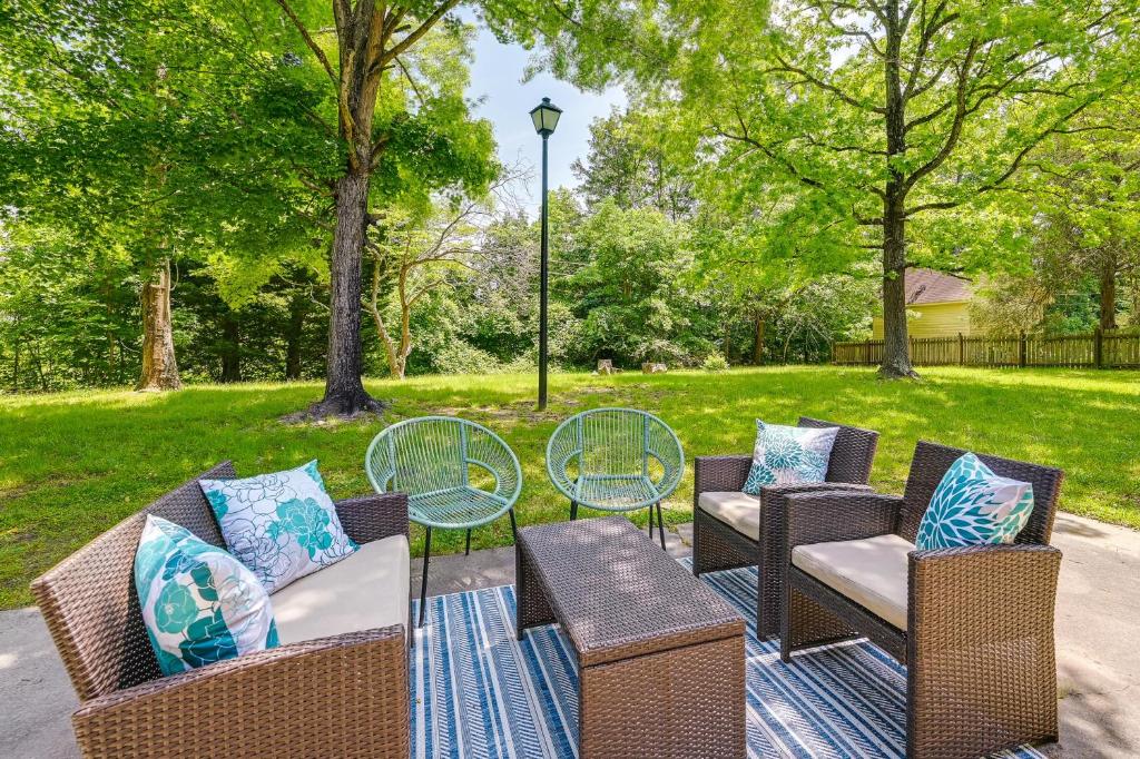 a patio with chairs and tables in a park at Cozy High Point Vacation Rental Near HPU Campus in High Point
