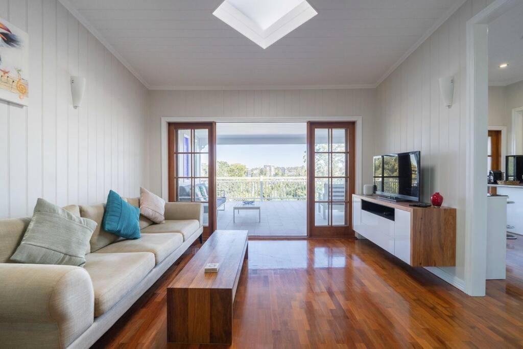 a living room with a couch and a tv at West End Luxury 4B3B Home w Parking and Home Pod Music System M9 in Brisbane
