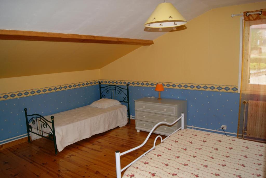 a bedroom with a bed and a dresser and a window at Durand Yves in Régnié