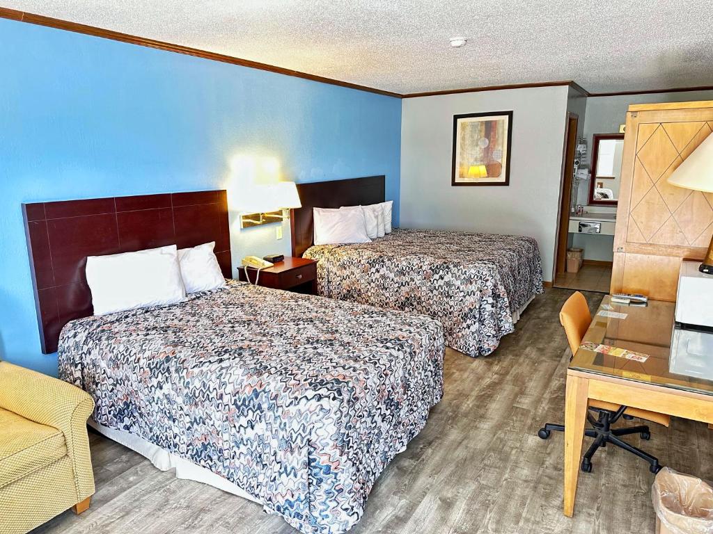 a hotel room with two beds and a desk at Night Inn in Sweet Springs