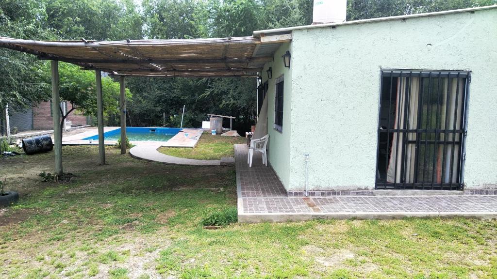 a small house with a patio and a swimming pool at DON CASTRO ALOJAMIENTO in San Roque